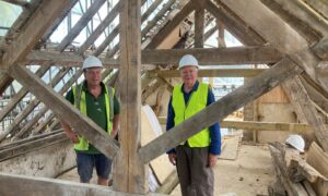 Jason Ive Building and Carpentry and Andrew McCarthy Chair of TOCT view a repositioned and repaired roof truss Photo TOCT n Ian Cray