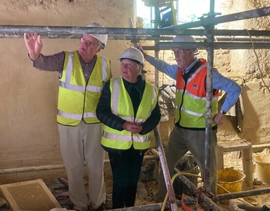 Photo of Andrew showing Chair of Dorset council the interior of Tolpuddler Old Chapel