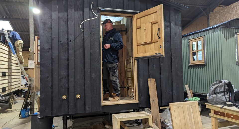 Charlie Waygood working on the hut for The Pig