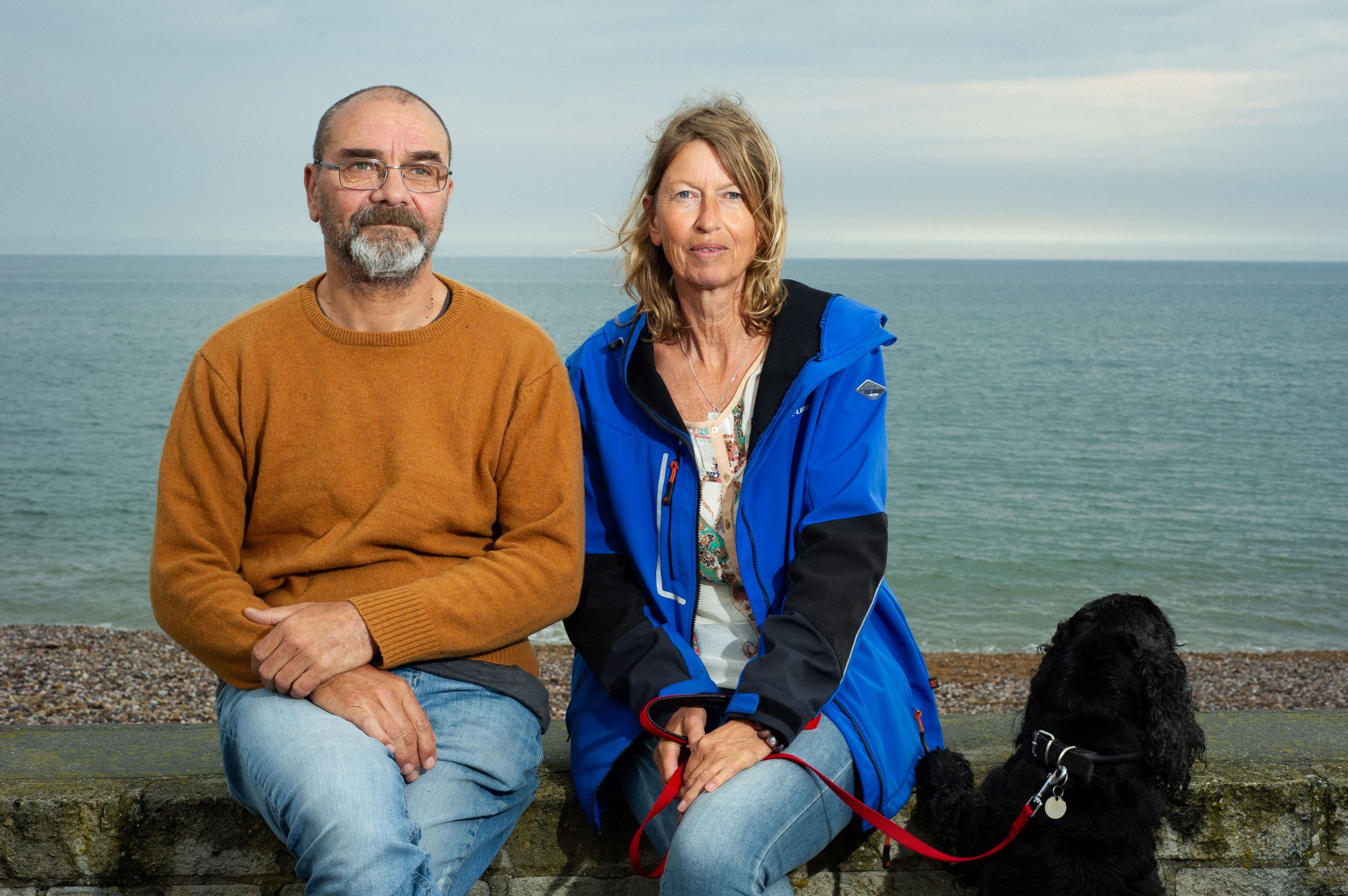 Andy with his friend Karin and Basil the cocker spaniel at the beach Pic Pete Millson scaled