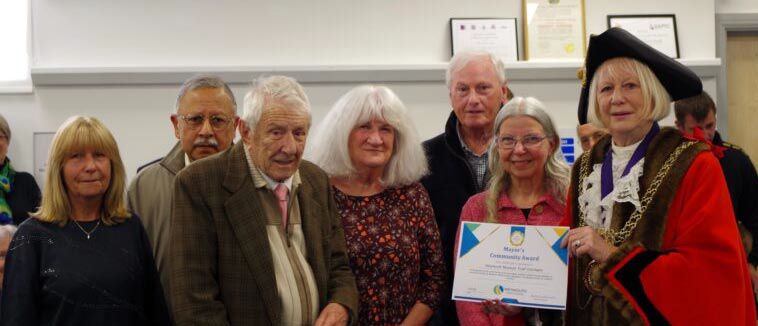 Mayor presents Weymouth volunteers at Weymouth Museum Trust with a Community Award certificate at the 2026 Mayor's Community Awards ceremony