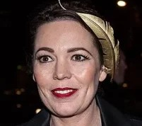 Actress Olivia Colman, who has backed the campaign to save Bridport's Lyric Theatre, pictured at an evening event wearing a gold leaf headpiece and black coat.
