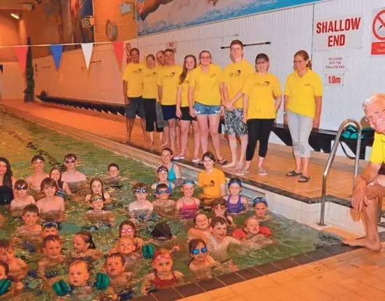 Bere Regis & District Swimming Club members and children pose poolside to celebrate the club's 50th anniversary