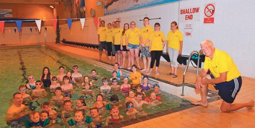 Bere Regis & District Swimming Club members and children pose poolside to celebrate the club's 50th anniversary
