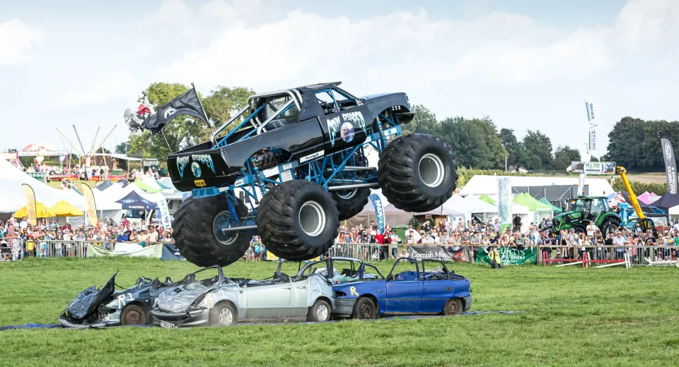 The Grim Reaper monster truck flies over crushed cars in front of a large crowd at Dorset County Show 2026