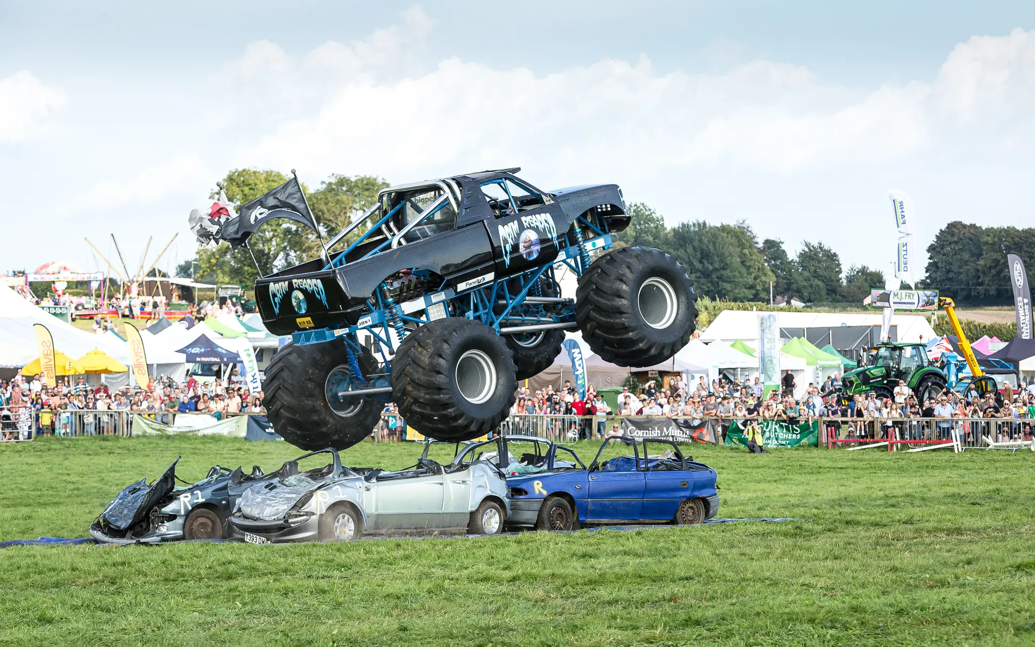The Grim Reaper monster truck flies over crushed cars in front of a large crowd at Dorset County Show 2026