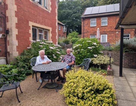 Molly Rennie and John Christmas of Dorchester Almshouses sit together in the garden of the Whetstones social housing scheme in West Walks, Dorchester