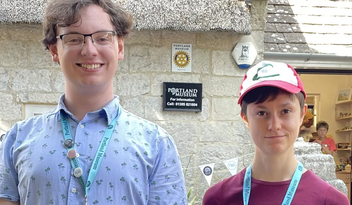 Jack Durie and Penelope Bentham, young volunteers at Portland Museum Dorset, standing outside the museum building