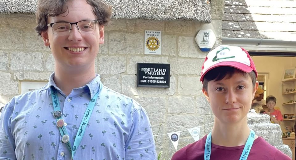 Jack Durie and Penelope Bentham, young volunteers at Portland Museum Dorset, standing outside the museum building