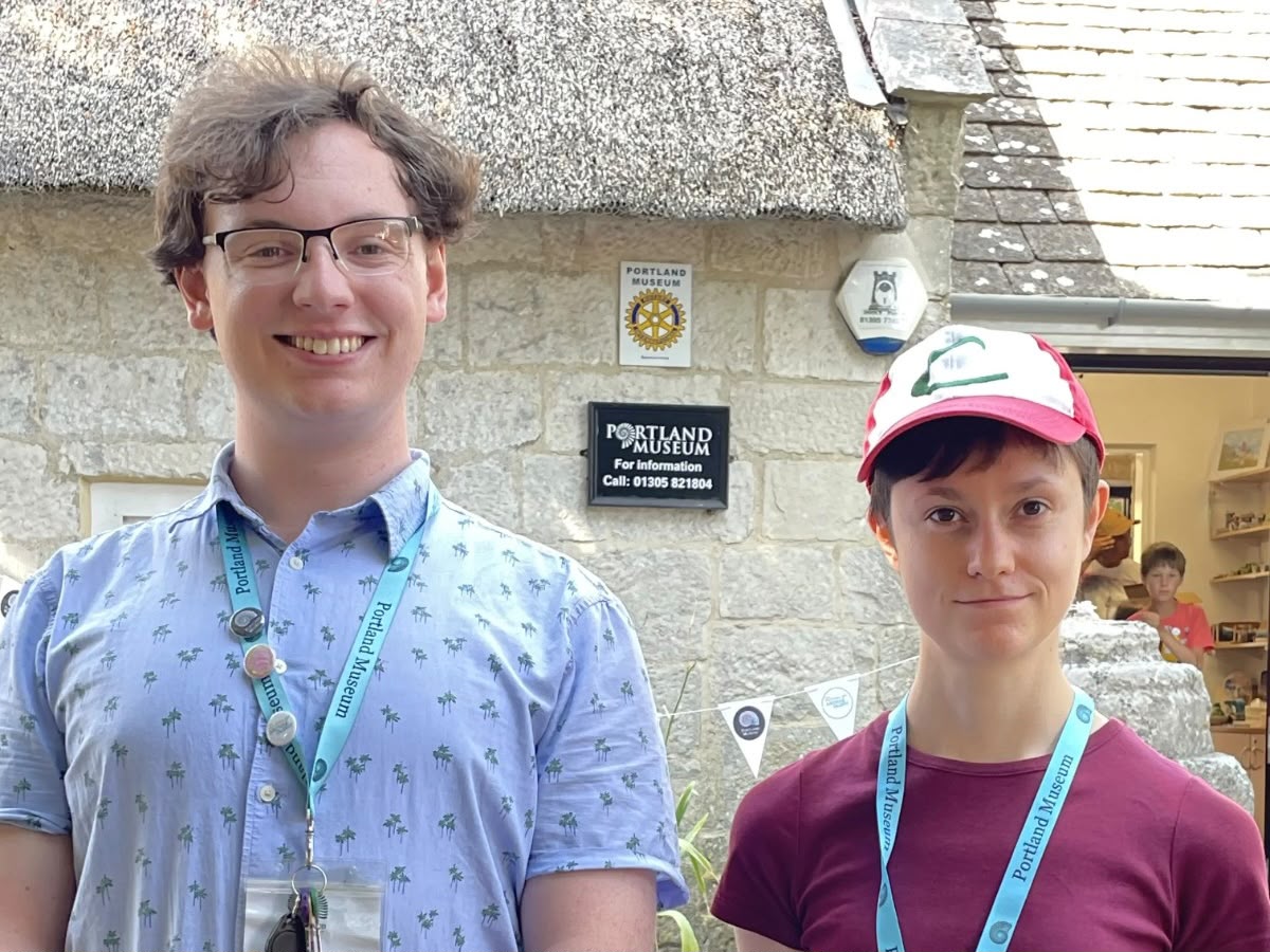 Jack Durie and Penelope Bentham, young volunteers at Portland Museum Dorset, standing outside the museum building