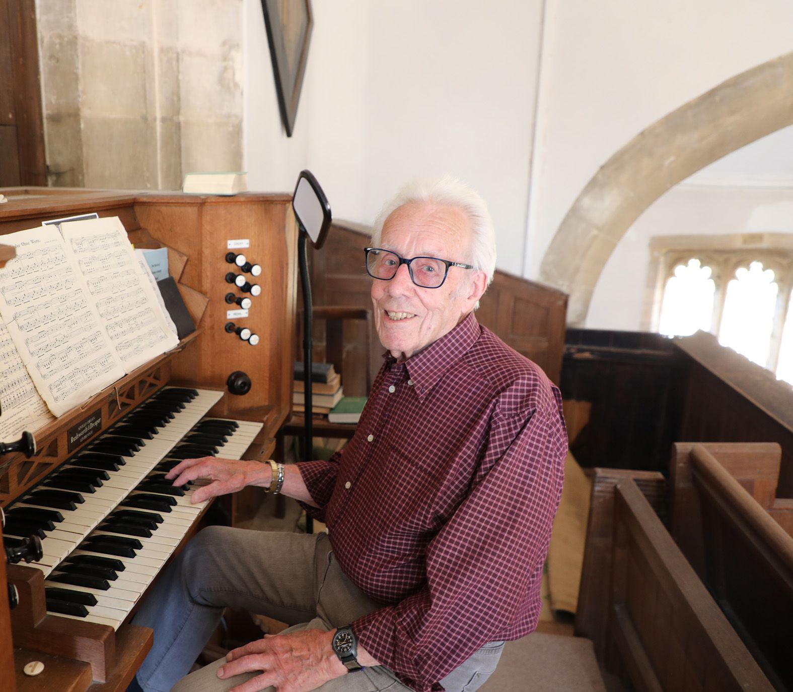 Church organist Keith Watts, 88, sits at the reed organ at Thomas a Becket Church, Lydlinch, where he has played for 73 years