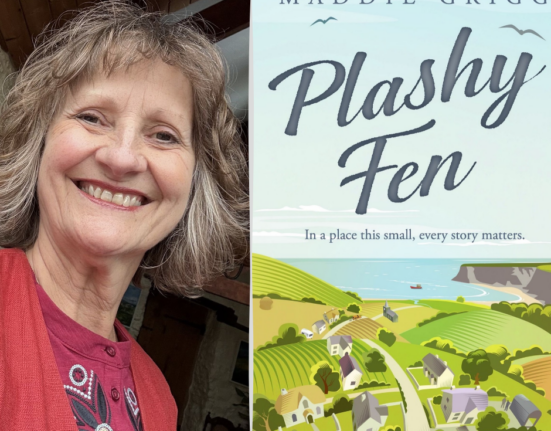 Author Margery Hookings, who writes as Maddie Grigg, smiling beside the cover of her novel Plashy Fen, which shows an illustrated Dorset village of cottages and green fields leading down to the sea